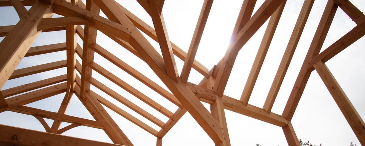 View of timber frame valley in great room KD doug fir