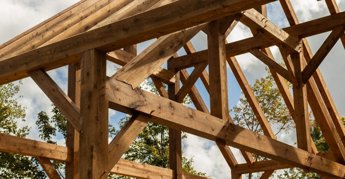 Queens post truss spanning a custom timber frame great room